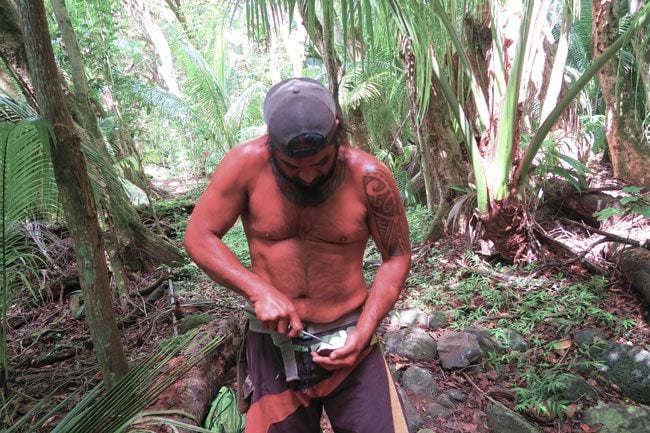 Halawa Valley Hike - Guide opening coconut - Molokai Hawaii