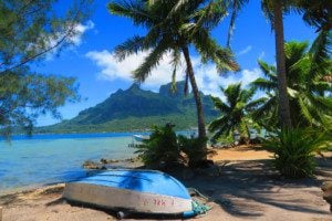 mountain and boat on beach in bora bora french polynesia