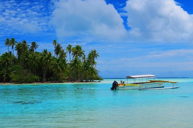 tropical beach with boat at le tahaa luxury resort french polynesia