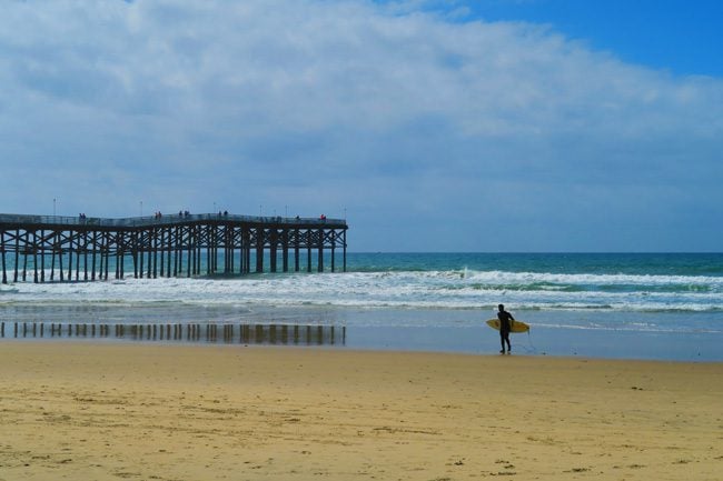 Pacific Beach Pier and surfer