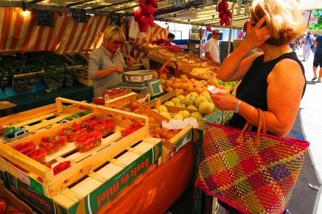 Buying food at Edgar Quinet Market Paris