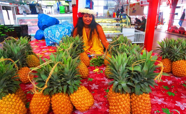 Pineapple and beautiful Tahitian at Papeete Market