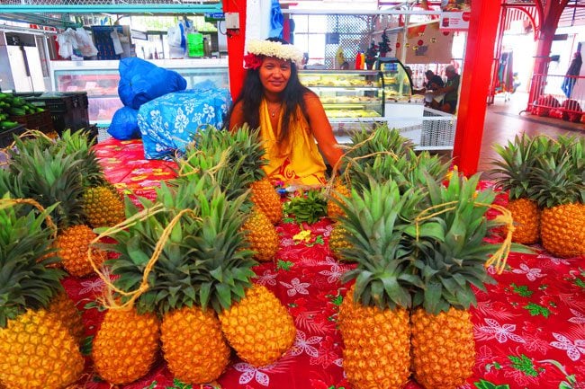 Pineapple and beautiful Tahitian at Papeete Market