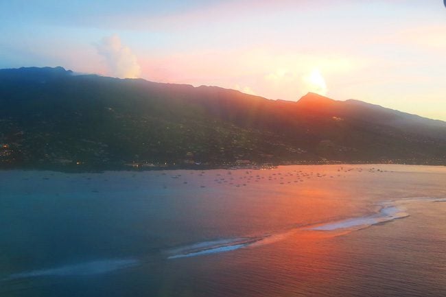 Sunset over Tahiti French Polynesia from plane