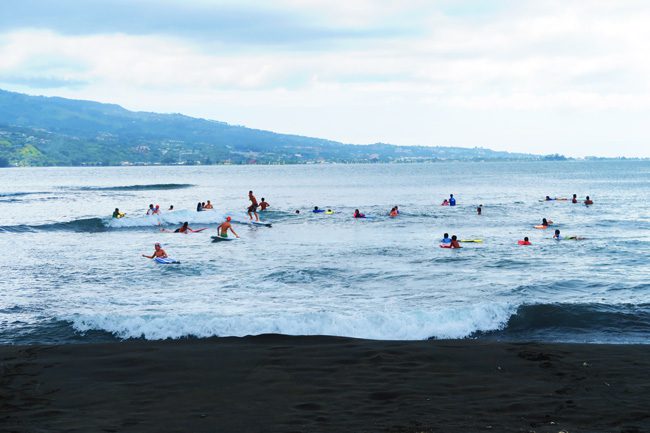 Surfers at pointe venus beach Tahiti French Polynesia