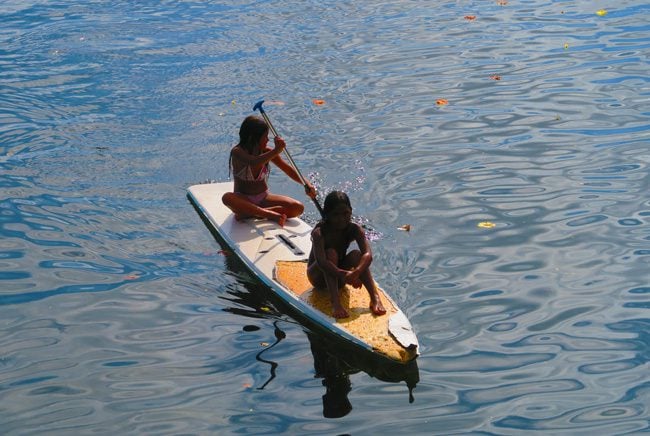 Teahupoo Beach Tahitian kids on surf board Tahiti French Polynesia