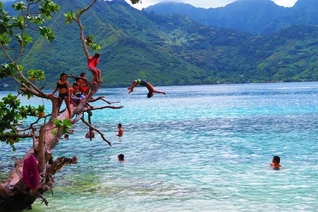 Mareto Beach Moorea French Polynesia children jumping