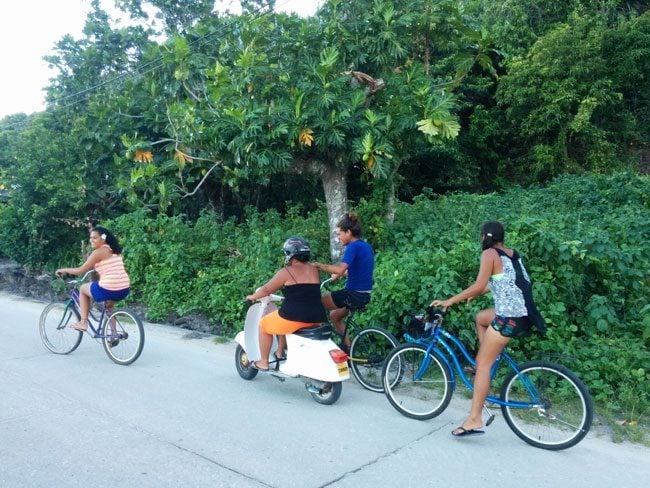 Islanders riding bike in Maupiti French Polynesia