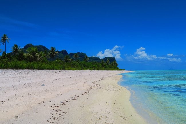 Motu Auira tropical beach view of Maupiti reef side