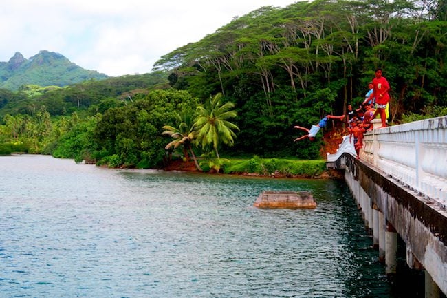 jumping from Huahine bridge French Polynesia