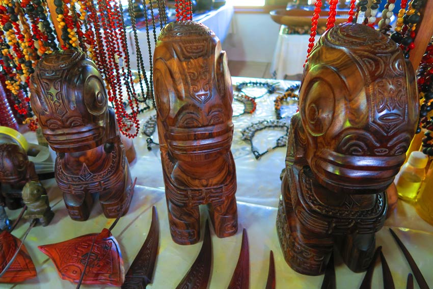 wood tiki statues in nuku hvia artits market marueqsas islands french polynesia