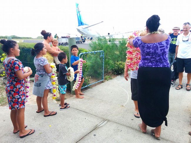 arriving in aitutaki airport flower necklace