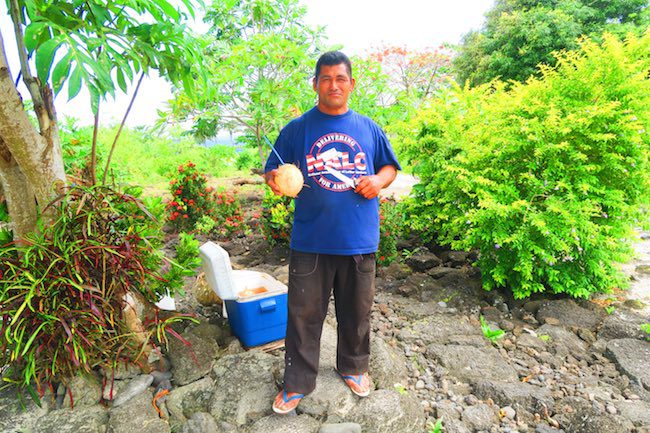 local samoan selling coconut in savaii