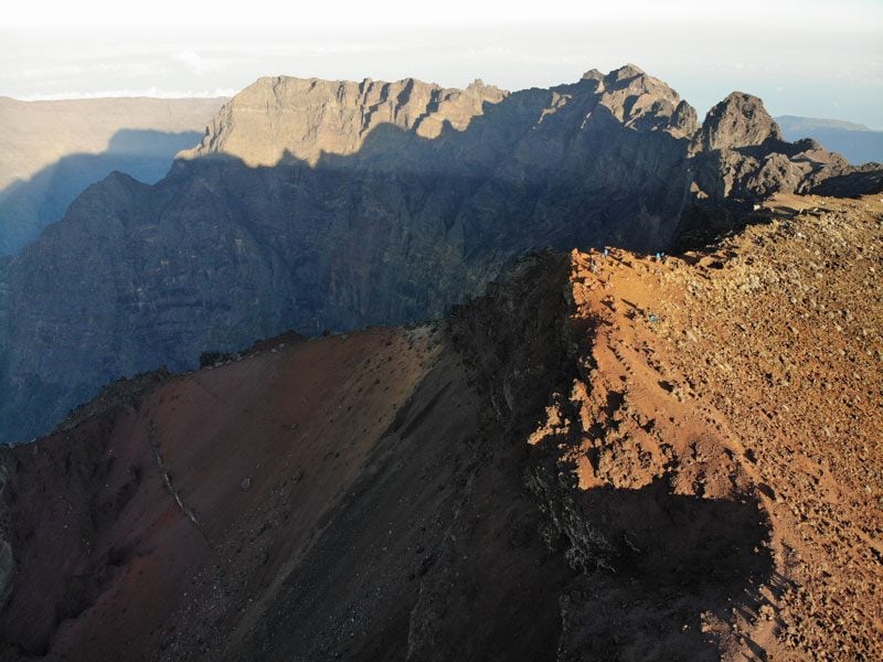 Summit of Piton des Neiges Hike - Reunion Island - Hikers at summit from above