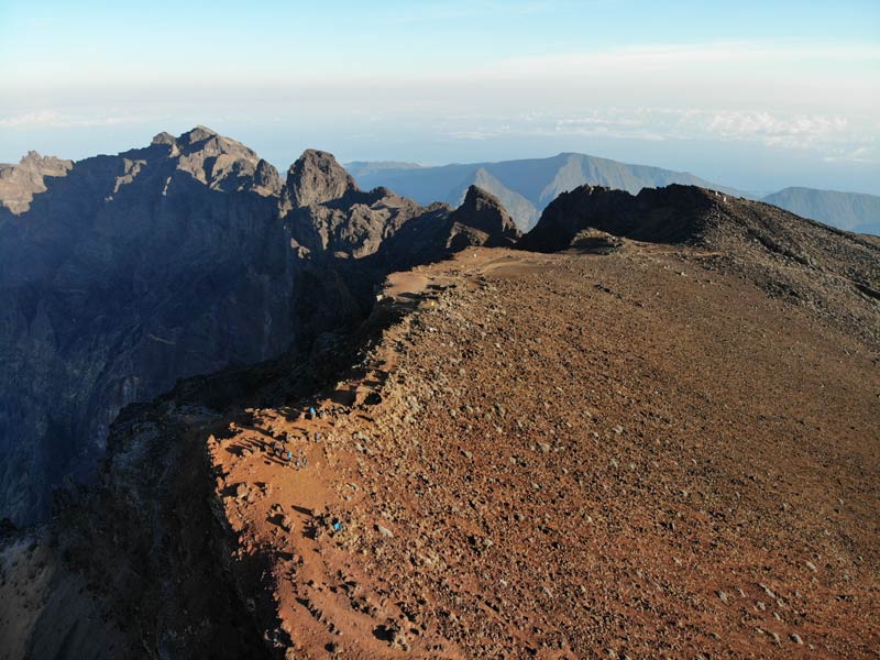 Summit of Piton des Neiges Hike - Reunion Island - Hikers at summit red earth