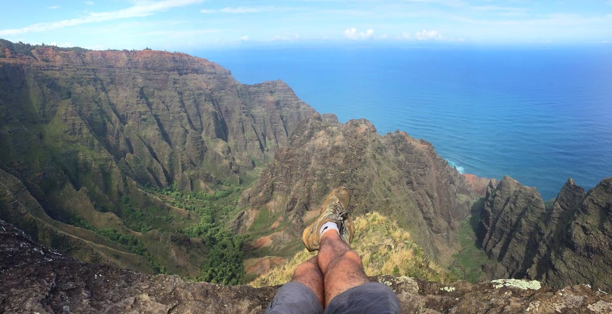 Sitting-on-ledge-Awaawapuhi-Trail-Na-Pali-Cliffs-Kauai-Hawaii