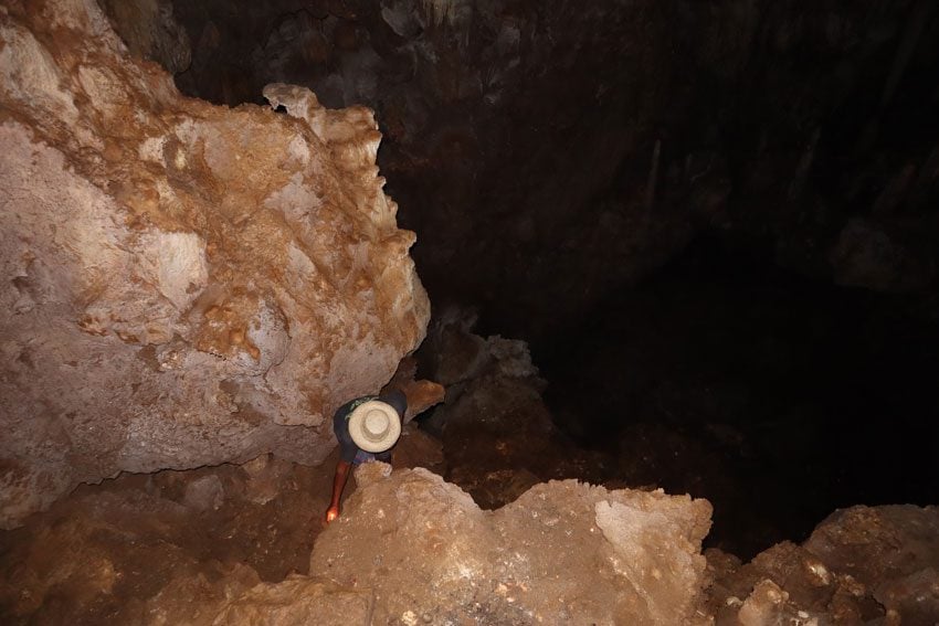 lighting candles in secret cave - rurutu - austral islands - french polynesia