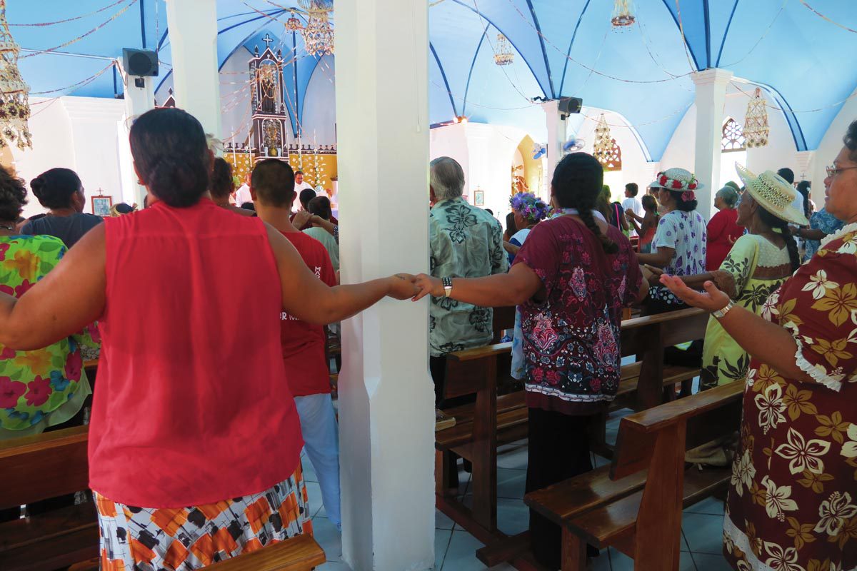 Holding hands in Sunday church service in Fakarava