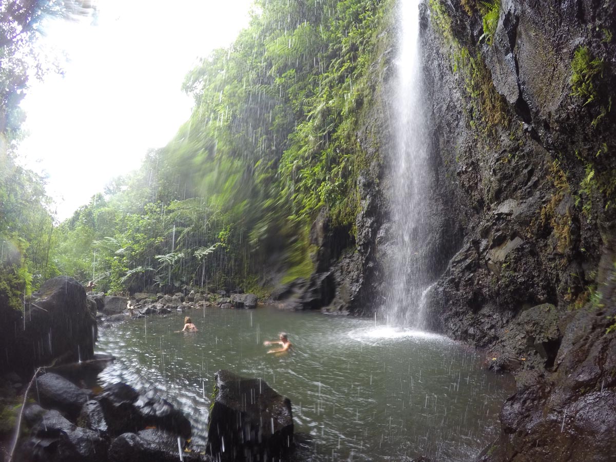 Three-Waterfalls-Hike-Les-Trois-Cascades-Raiatea-behind-watrefall