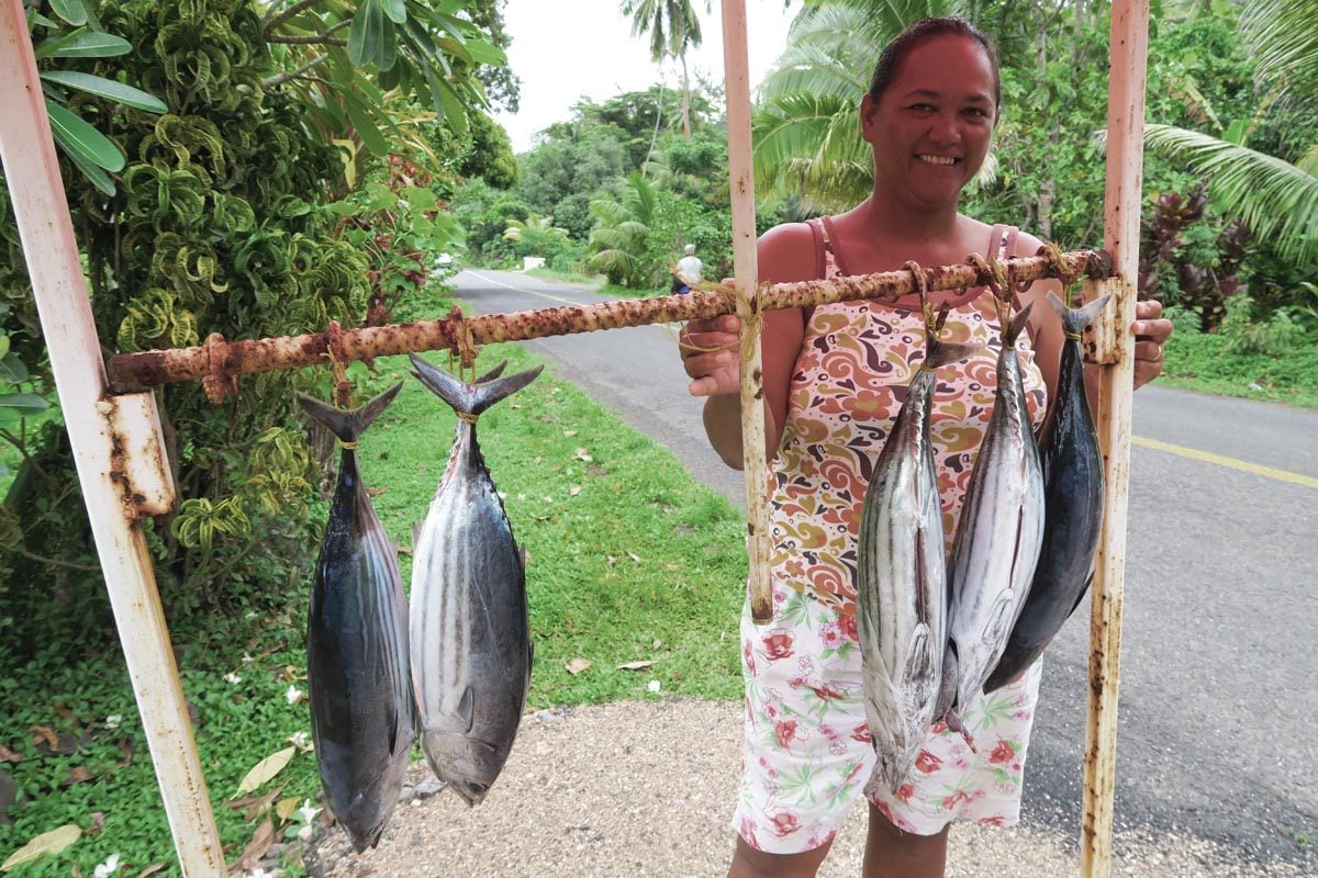 Local selling fish on roadside - Moorea