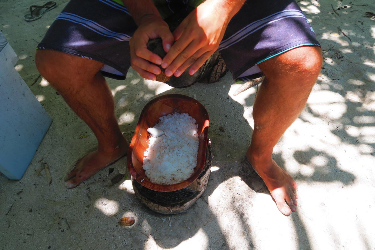 Maupiti lagoon tour - motu picnic - grating coconut