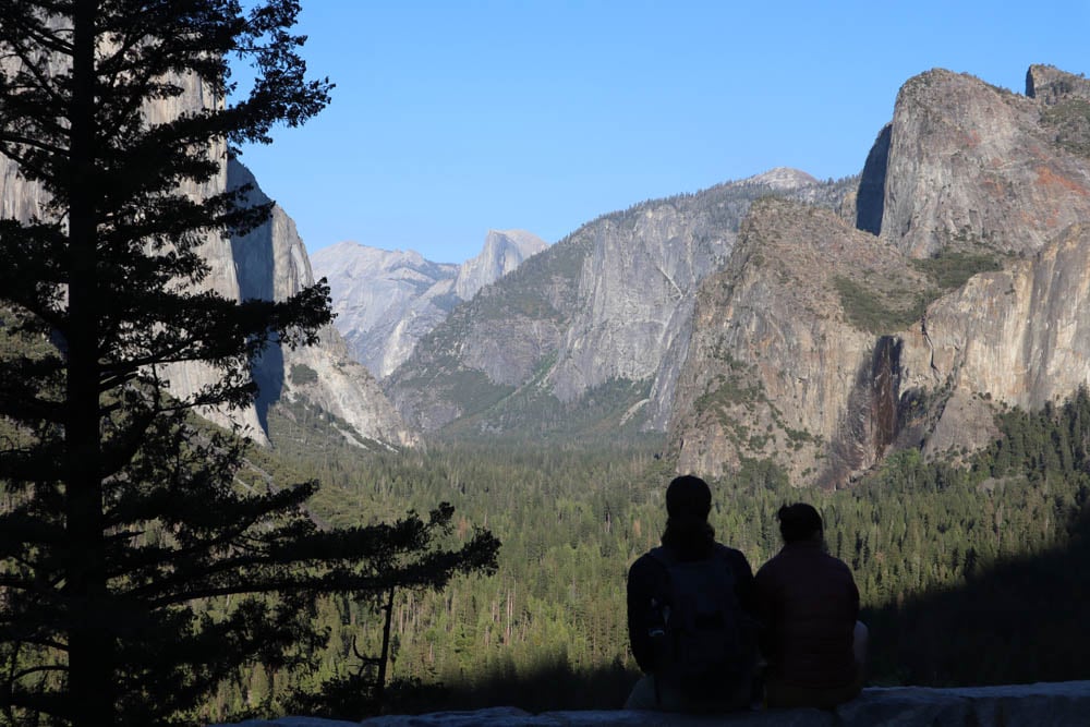 Couple looking at Yosemite Valley from bridge lookout