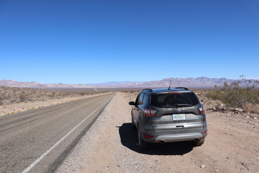 Greatest American Road Trip - car in death valley straight road