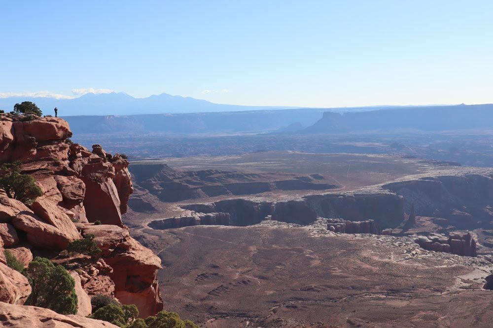 Hiker on rim at Grand View point trail - island in the sky - canyonlands national park - utah