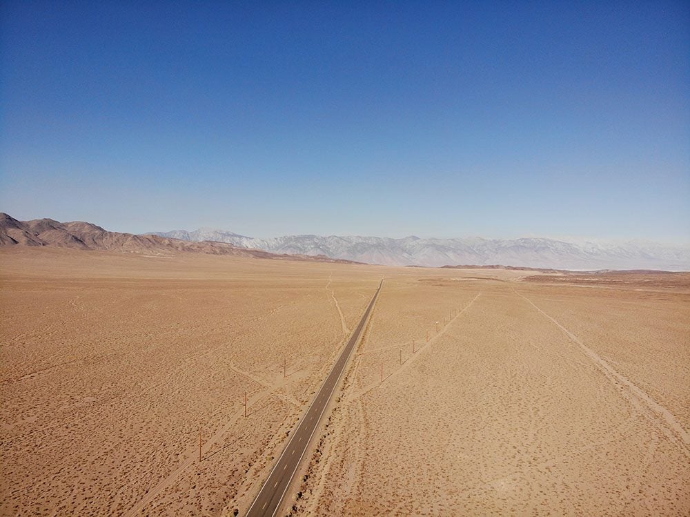 Driving to death valley from Lone Pine california on straight desert road in Mojave Desert