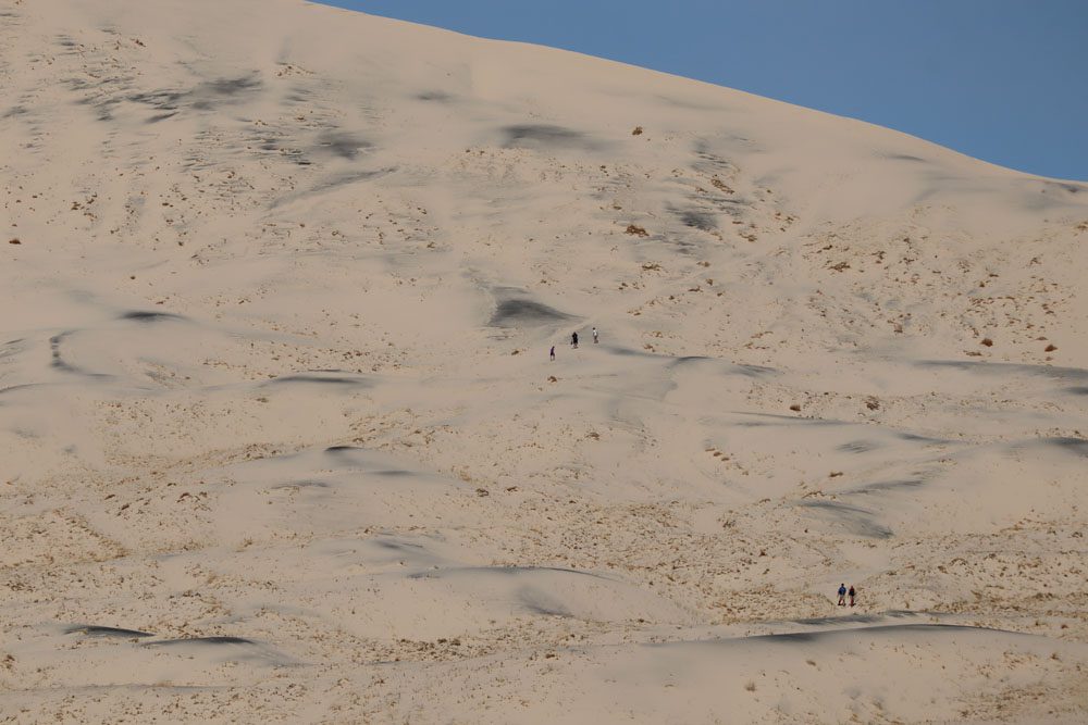 Hiker on Kelso Dunes trail - mojave national preserve