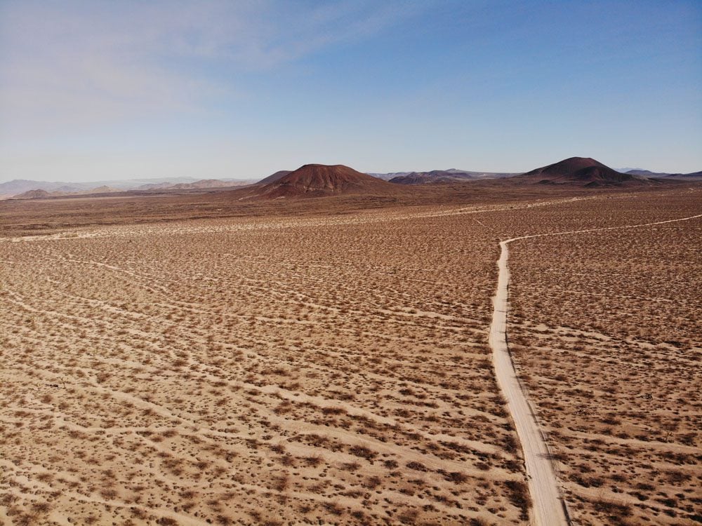 volcanic-cinder-cones-and-dirt-road-in-mojave-national-preserve