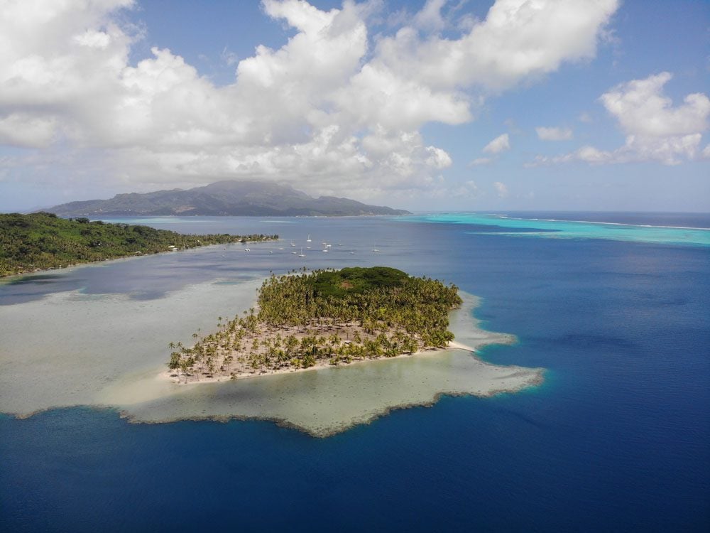 Motu-in-Apu-Bay-and-Raiatea-in-background-Tahaa-French-Polynesia.