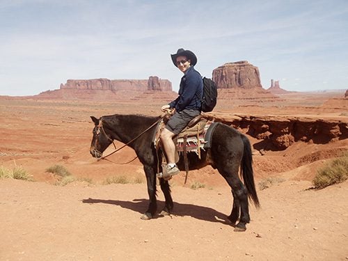 riding a horse in monument valley