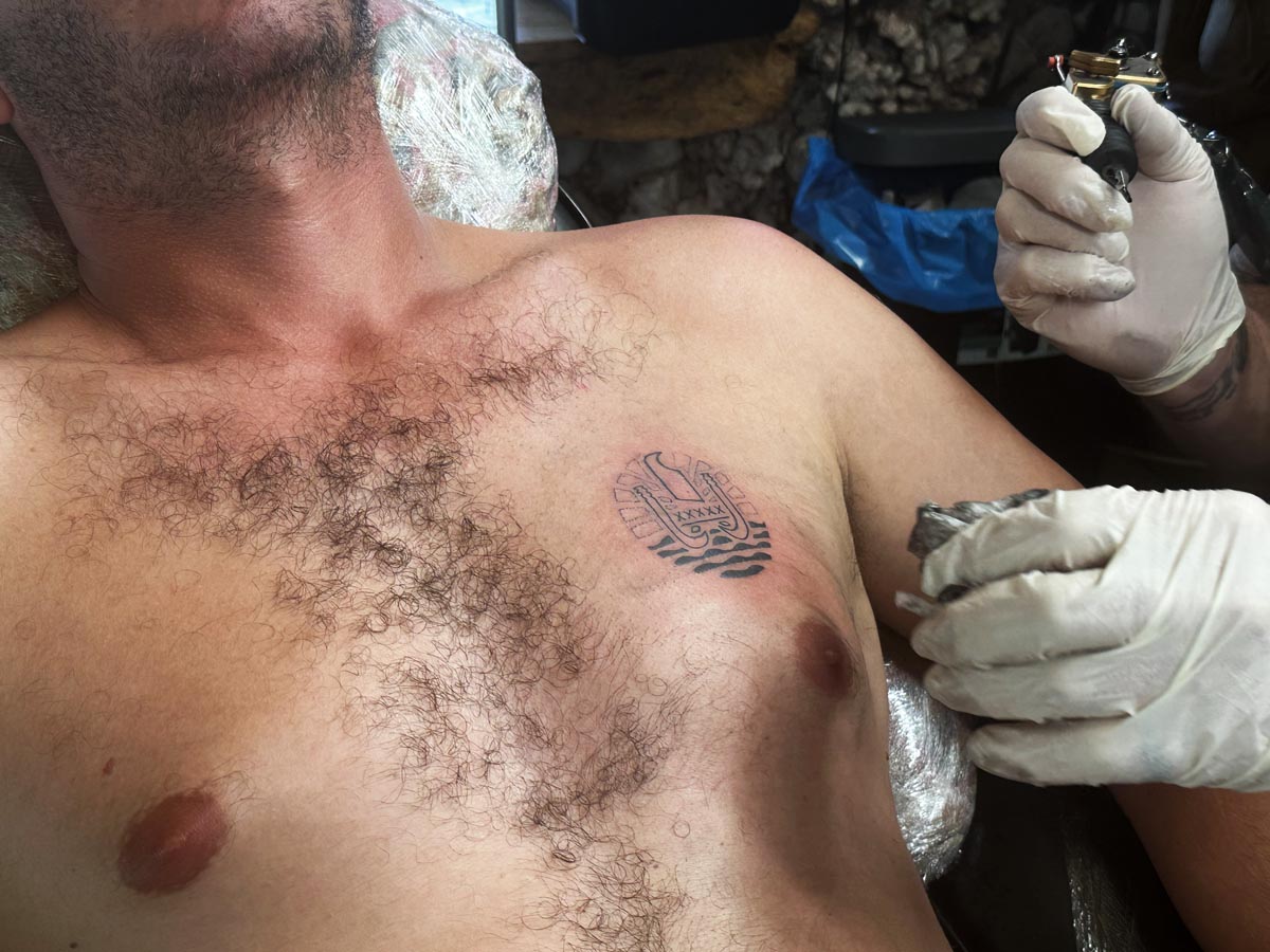 Avichai getting a tattoo in Moorea - closeup
