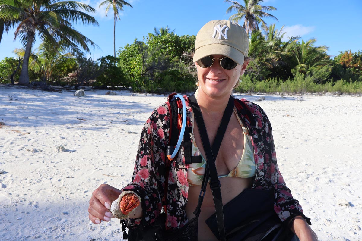 Ella holding crab in Motu Auira - Maupiti