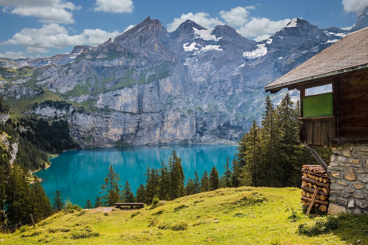 Log cabin next to emerald lake in switzerland