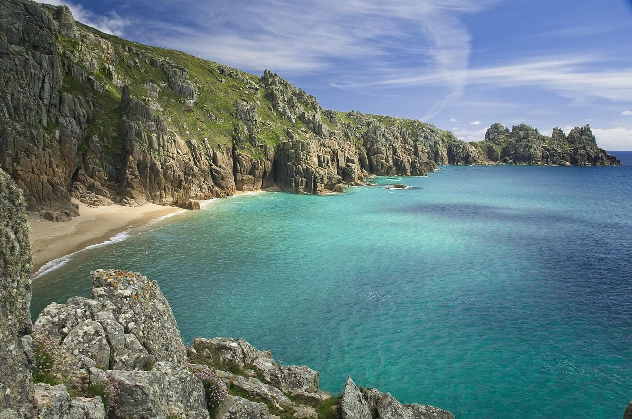 a white sand beach and cliffs in Cornwall UK