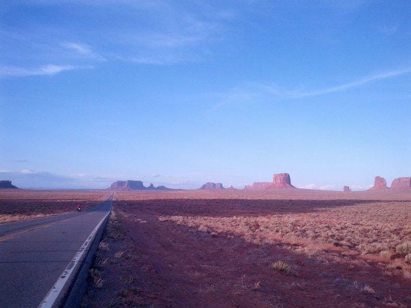 Straight desert road to Monument Valley
